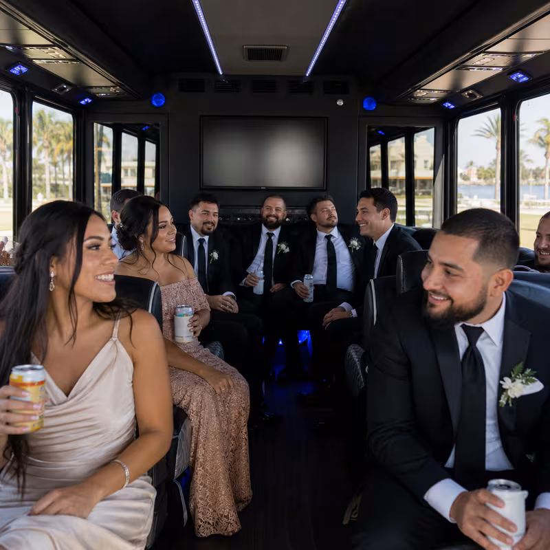 Wedding guests seated inside a Fort Myers party bus