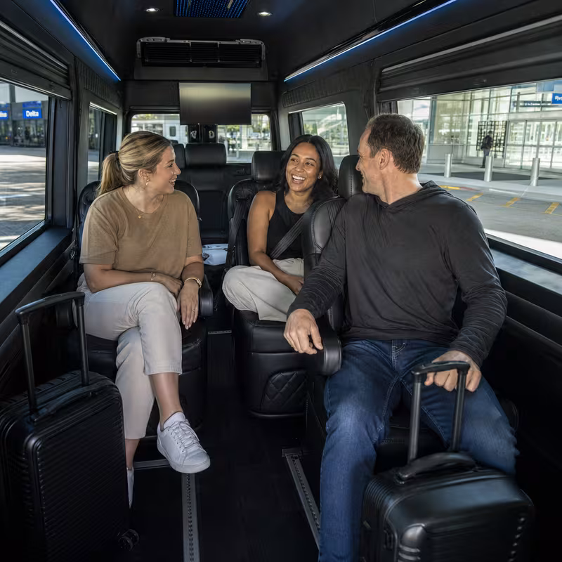 Passengers loading luggage while boarding an Fort Myers group shuttle