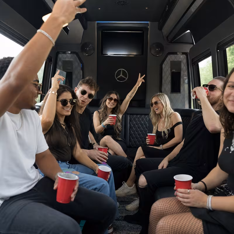 Group boarding a white charter bus for Concert Transportation transportation in Fort Myers