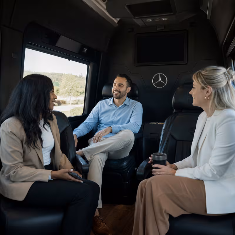 Group boarding a white charter bus for Corporate Transportation transportation in Fort Myers