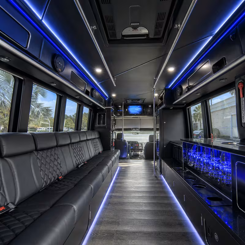 Party bus interior with wraparound leather seating and LED lighting in Fort Myers