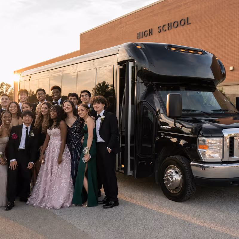 Group boarding a white charter bus for Prom & Homecoming Transportation transportation in Fort Myers