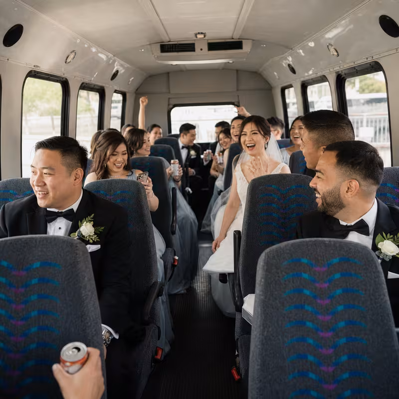 Group boarding a white charter bus for Wedding Transportation transportation in Fort Myers