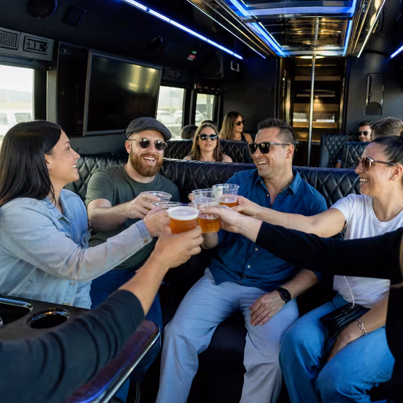 Group boarding a white charter bus for Winery & Brewery Tour Transportation transportation in Fort Myers