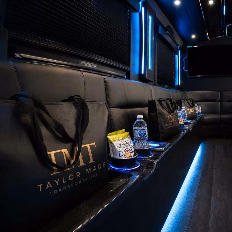 Party bus interior with wraparound leather seating and LED lighting in Fort Myers